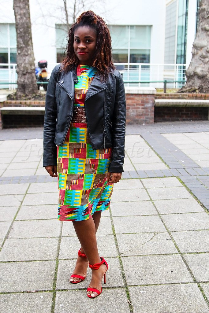 Kente shift dress, black biker jacket & red heeled sandals