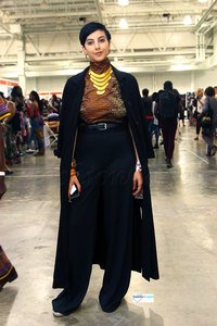Ankara/kitenge/chitenge/African print High neck top with black high waist wide leg loose pants, black over the shoulder long coat, gold statement necklace and bangles : Styling African style - Street Style