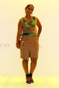 Brown & ‘kitenge’/’ankara’/African print peplum dress with plunging deep V neckline & asymmetric split with emerald green necklace, earrings & clutch bag