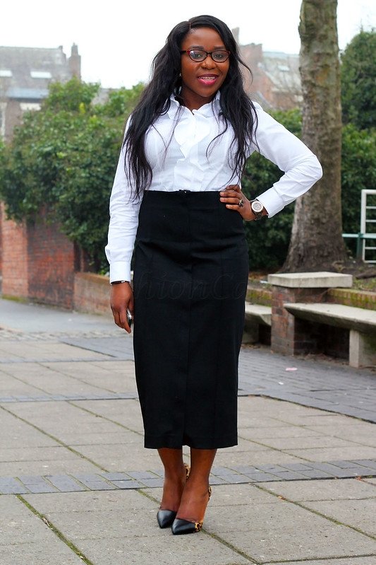 White ruffle long sleeved shirt with a black zip front midi skirt & black & leopard print heels: Office wear